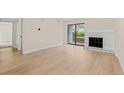 Spacious living room with a fireplace and sliding glass doors to the outside at 3141 S Tamarac Dr # 111G, Denver, CO 80231