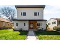 Contemporary two-story home with a minimalist design, well-manicured lawn, and inviting walkway at 1265 Niagara St, Denver, CO 80220