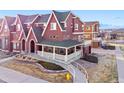 Charming two-story home with a covered porch, brick accents, and manicured landscaping at 18028 French Creek Ave, Parker, CO 80134