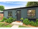 Exterior of home features black trim and window boxes filled with flowers at 1411 S Beach Ct, Denver, CO 80219