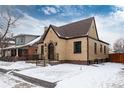 Charming brick home featuring a stone entryway, well-maintained landscaping and a classic peaked roof design at 475 S Race St, Denver, CO 80209