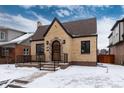 Charming brick home featuring a stone entryway, well-maintained landscaping and a classic peaked roof design at 475 S Race St, Denver, CO 80209