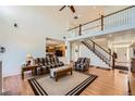 Bright, open living room with high ceilings, hardwood floors and staircase to second floor at 17456 Quarry Way, Monument, CO 80132