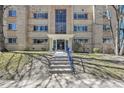Charming brick apartment building with well-maintained landscaping and inviting front entrance with blue railings at 85 N Ogden St # 13, Denver, CO 80218