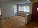 Bright living room area with large bay windows and a cozy window seat, ready to be updated at 2477 S Oakland Cir, Aurora, CO 80014