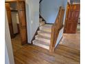 Staircase with wood banister and hardwood floors leading to the upper level of the home at 2477 S Oakland Cir, Aurora, CO 80014