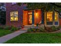 Charming front porch with decorative columns, American flag, and landscaped garden beds for added curb appeal at 7064 E 2Nd Ave, Denver, CO 80220