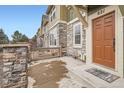 Close-up of front porch with stone and wood features leading up to the entrance door at 821 Stony Mesa Pl, Castle Rock, CO 80108