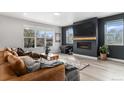Cozy living room boasts a fireplace, large windows, and a comfortable seating area at 3580 W 62Nd Pl, Denver, CO 80221