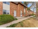 Charming brick townhome exterior with well-kept landscaping and inviting entrance at 4555 S Lowell Blvd, Denver, CO 80236