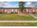 A row of well-kept townhomes on a lush green lawn showcasing a desirable community at 4555 S Lowell Blvd, Denver, CO 80236