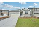 Charming single-Gathering home featuring stone accents, a two-car garage, and a well-manicured lawn at 1957 S Coolidge Way, Aurora, CO 80018