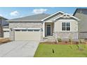 Close up of a lovely single-Gathering home featuring stone accents and a two-car garage at 1957 S Coolidge Way, Aurora, CO 80018