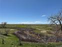 Scenic view of the golf course and surrounding landscape on a beautiful day at 1957 S Coolidge Way, Aurora, CO 80018