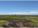 Scenic view of the golf course and surrounding landscape on a beautiful day at 1957 S Coolidge Way, Aurora, CO 80018