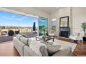 Living room featuring a marble fireplace, oversized sliding glass doors to a patio, and golf course views at 93 Glenmoor Dr, Cherry Hills Village, CO 80113