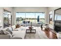 Comfortable living room with fireplace, patio access, and stunning views of the golf course at 93 Glenmoor Dr, Cherry Hills Village, CO 80113