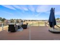 Outdoor patio with comfortable seating and expansive golf course and mountain views at 93 Glenmoor Dr, Cherry Hills Village, CO 80113