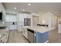 Modern kitchen with white cabinets, stainless steel appliances, and an island at 18455 W 94Th Ave, Arvada, CO 80007