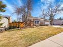 Attractive home showcasing a cozy brick accent wall and a lush front yard at 3706 E Easter Dr, Centennial, CO 80122