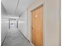 Long hallway with gray carpet leading to unit door with number 58, lit by ceiling lights at 4110 Hale Pkwy # 5F, Denver, CO 80220