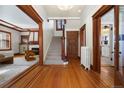 Inviting foyer with hardwood floors, staircase, and decorative woodwork leading into a cozy living space at 1827 N Bellaire St, Denver, CO 80220