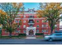 A striking brick building with trees lining the street, complemented by classic architectural details at 836 E 17Th Ave # 2E, Denver, CO 80218