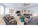 Cozy living room with hardwood floors, stylish furniture, a ceiling fan, and natural light at 7966 Ingalls St, Arvada, CO 80003