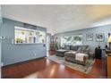 Inviting living room with a large sectional sofa, area rug, and natural light at 5745 W Atlantic Pl # 104, Lakewood, CO 80227