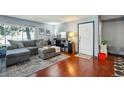 Comfortable living room featuring a gray sectional sofa, front door, and hardwood flooring at 5745 W Atlantic Pl # 104, Lakewood, CO 80227