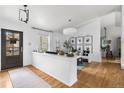 Bright, open-concept living room with hardwood floors, a modern decor, and a partial wall at 6686 E Jamison Ave, Centennial, CO 80112