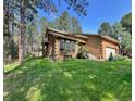 Charming single Gathering home with green lawn and mature landscaping at 85 S Sherwood Gln, Monument, CO 80132