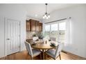 Bright eat-in kitchen area features wood table and chairs and natural light at 8802 E 148Th Ln, Thornton, CO 80602