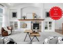 Cozy living room with a fireplace, built-in shelving, and neutral decor creating a relaxing atmosphere at 8802 E 148Th Ln, Thornton, CO 80602