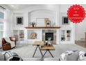 Inviting living room features built-in shelving, fireplace with stone surround, and modern decor at 8802 E 148Th Ln, Thornton, CO 80602