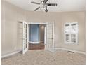 Bright home office featuring french doors, neutral walls and a window with shutters at 8802 E 148Th Ln, Thornton, CO 80602