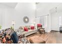 Bright living room with hardwood floors, cozy seating, and high ceilings at 8551 Gold Peak Dr # B, Highlands Ranch, CO 80130