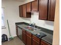 Functional kitchen with wood cabinets, a double sink, and durable countertops at 7870 Magnolia St, Commerce City, CO 80022