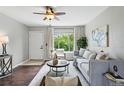 Cozy living room with hardwood floors, a ceiling fan, a large window, and neutral decor at 1047 Scranton St, Aurora, CO 80011