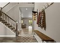 Bright foyer with hardwood floors and staircase leading to the upper level at 6827 Leilani Ln, Castle Rock, CO 80108
