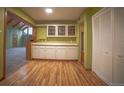 Dining area with hardwood floors, white cabinets, and open access to other rooms at 814 Rose St, Georgetown, CO 80444