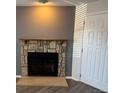 Living room fireplace with stone surround and wood mantel at 992 S Dearborn Way # 7, Aurora, CO 80012