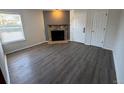 A bright living room featuring neutral paint, stone fireplace, and modern wood floors at 992 S Dearborn Way # 7, Aurora, CO 80012