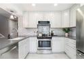 Well-equipped kitchen featuring stainless steel appliances and bright white cabinets at 2645 S Xanadu Way # D, Aurora, CO 80014