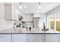 Bright kitchen with stainless steel appliances, spacious countertops and white cabinets at 2645 S Xanadu Way # D, Aurora, CO 80014