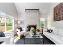 Cozy living room with stone fireplace, hardwood floors, and ample natural light at 2645 S Xanadu Way # D, Aurora, CO 80014