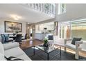 Spacious living room features hardwood floors, a modern kitchen view, and an open floor plan at 2645 S Xanadu Way # D, Aurora, CO 80014