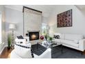 Bright living room featuring fireplace, with white couches and chairs at 2645 S Xanadu Way # D, Aurora, CO 80014