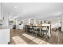 Bright dining room with hardwood floors flowing into an open kitchen featuring stainless steel appliances at 7600 Kline Dr, Arvada, CO 80005