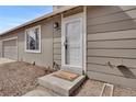 Close up of front door with small porch and visible house number, mat that says 'home' at 15650 E Eldorado Dr, Aurora, CO 80013
